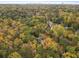 An aerial view showcases the homes nestled in a vibrant, tree-filled landscape with city skyline in the distance at 1153 Dawn View Nw Ln, Atlanta, GA 30327