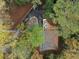 Beautiful aerial shot of a property featuring a spacious deck and a circular driveway nestled in trees at 1153 Dawn View Nw Ln, Atlanta, GA 30327