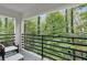Relaxing balcony, featuring chairs, a black railing, and a scenic natural view at 1153 Dawn View Nw Ln, Atlanta, GA 30327