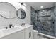 Beautiful bathroom featuring modern fixtures, double sinks, and a walk-in shower with unique tiling at 1153 Dawn View Nw Ln, Atlanta, GA 30327