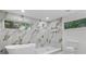 Luxurious bathroom with a soaking tub, walk-in shower, and marble tile at 1153 Dawn View Nw Ln, Atlanta, GA 30327