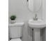 Modern bathroom, featuring toilet, sink, mirror, and small plant decoration at 1153 Dawn View Nw Ln, Atlanta, GA 30327