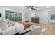 Modern bedroom with a ceiling fan, area rug and a sliding glass door leading to a balcony at 1153 Dawn View Nw Ln, Atlanta, GA 30327