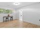 Bright, wood floored bedroom with stylish stools, views, and an ensuite bath beyond at 1153 Dawn View Nw Ln, Atlanta, GA 30327