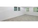 A bright bedroom with tile flooring and three windows overlooking the exterior trees and landscape at 1153 Dawn View Nw Ln, Atlanta, GA 30327