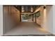 Spacious carport area with modern lighting, offering covered parking and access to the home at 1153 Dawn View Nw Ln, Atlanta, GA 30327