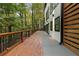 Long deck with wood railing running alongside a modern home with a wooded view at 1153 Dawn View Nw Ln, Atlanta, GA 30327