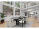 Open-concept dining room with large windows, hardwood floors, and modern chandelier at 1153 Dawn View Nw Ln, Atlanta, GA 30327
