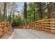 Long driveway leading to the home, bordered by a wooden fence and lush greenery at 1153 Dawn View Nw Ln, Atlanta, GA 30327