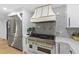 The kitchen features a stainless steel refrigerator, white cabinets and oven range with gold trim at 1153 Dawn View Nw Ln, Atlanta, GA 30327