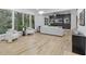 Spacious and bright living room with hardwood floors, plush neutral furniture, and access to nature views at 1153 Dawn View Nw Ln, Atlanta, GA 30327
