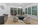 Bright living room with hardwood floors, plush neutral furniture, and glass doors to the back deck at 1153 Dawn View Nw Ln, Atlanta, GA 30327