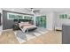 Bright main bedroom with hardwood floors, dark gray accent wall and sliding glass doors to a balcony at 1153 Dawn View Nw Ln, Atlanta, GA 30327
