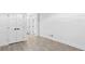 Large room featuring white walls and tile flooring, with multiple doors and neutral aesthetic at 1153 Dawn View Nw Ln, Atlanta, GA 30327