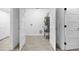 Spacious utility room, featuring tile flooring, white walls, doors, and a water heater at 1153 Dawn View Nw Ln, Atlanta, GA 30327