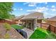 Beautiful backyard featuring a screened porch, patio, and a well-maintained lawn at 2212 Nichols Valley Drive, Dacula, GA 30019