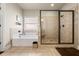 Bathroom featuring a soaking tub, walk-in shower, and neutral tile, creating a relaxing atmosphere at 2212 Nichols Valley Drive, Dacula, GA 30019