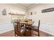 Cozy breakfast nook with a dark wood table set for four, a window and modern decor at 2212 Nichols Valley Drive, Dacula, GA 30019