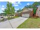 Beautiful home with a well-manicured lawn and a long driveway leading to a two-car garage at 2212 Nichols Valley Drive, Dacula, GA 30019
