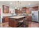 Well-appointed kitchen with granite countertops, a center island, stainless steel appliances, and dark wood cabinetry at 2212 Nichols Valley Drive, Dacula, GA 30019