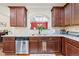 Modern kitchen with stainless steel appliances, granite countertops, and dark wood cabinets at 2212 Nichols Valley Drive, Dacula, GA 30019