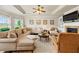Inviting living room boasts tray ceilings, a fireplace, and comfortable seating arrangement at 2212 Nichols Valley Drive, Dacula, GA 30019