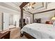 Spacious main bedroom suite with a four-poster bed, sitting area, and coffered ceiling at 2212 Nichols Valley Drive, Dacula, GA 30019