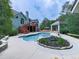 Backyard pool with a spacious deck, gazebo, and lush landscaping, offering a relaxing outdoor space at 302 Gilmer Ct, Canton, GA 30115