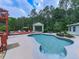 Backyard pool with a gazebo, deck, and surrounding greenery provides a perfect outdoor retreat at 302 Gilmer Ct, Canton, GA 30115
