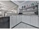 Bar area featuring white cabinets, a sink, a microwave, and shelves for storing drinks at 302 Gilmer Ct, Canton, GA 30115
