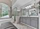 Spacious bathroom features a soaking tub, walk-in shower, and tile flooring at 302 Gilmer Ct, Canton, GA 30115