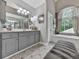 Beautiful bathroom featuring a large tub under an arched window and double sink vanity at 302 Gilmer Ct, Canton, GA 30115
