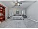 Bedroom featuring a cozy bed with a guitar, shelving unit, and windows at 302 Gilmer Ct, Canton, GA 30115