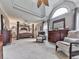 Bright, large bedroom with a sitting area, tray ceilings and neutral décor at 302 Gilmer Ct, Canton, GA 30115