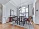 Elegant dining room featuring hardwood floors, large arched window, chandelier, and decorative molding at 302 Gilmer Ct, Canton, GA 30115