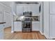 A well-lit kitchen features stainless steel appliances and ample white cabinetry at 302 Gilmer Ct, Canton, GA 30115