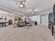 Spacious carpeted living room with ceiling fans, bar, sofa, and entertainment center at 302 Gilmer Ct, Canton, GA 30115
