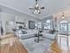 Spacious living room with hardwood floors, comfortable seating, and open access to the kitchen and dining areas at 302 Gilmer Ct, Canton, GA 30115