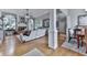 Bright and airy living room featuring hardwood floors, elegant columns, fireplace, and large windows at 302 Gilmer Ct, Canton, GA 30115