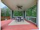 Comfortable covered patio with outdoor furniture and ceiling fan, creating a relaxing outdoor living space at 302 Gilmer Ct, Canton, GA 30115