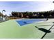 Well-maintained tennis court surrounded by lush greenery, perfect for recreation at 302 Gilmer Ct, Canton, GA 30115
