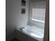 Clean bathroom featuring a soaking tub with chrome fixtures and a large window at 3242 Cascade Parc Sw Blvd, Atlanta, GA 30311