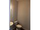 Neat half-bathroom with a corner sink, toilet, and wood-look flooring at 3242 Cascade Parc Sw Blvd, Atlanta, GA 30311