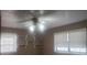 Bedroom with tan carpet, two windows and a ceiling fan at 5927 Sherrie Ln, Powder Springs, GA 30127