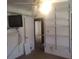 A bedroom featuring shelving units, ceiling fan, and a television mounted to the wall at 5927 Sherrie Ln, Powder Springs, GA 30127