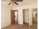 Bedroom with tan carpet, a ceiling fan and two closets at 5927 Sherrie Ln, Powder Springs, GA 30127