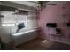 Bedroom featuring built-in shelving, a ceiling fan, television, and a window for natural light at 5927 Sherrie Ln, Powder Springs, GA 30127