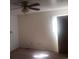 Bedroom with tan carpet, one window and ceiling fan at 5927 Sherrie Ln, Powder Springs, GA 30127