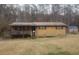 Exterior of a house with brown siding, covered front porch and wood steps at 5927 Sherrie Ln, Powder Springs, GA 30127