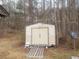 Outdoor storage shed in a wooded backyard setting at 5927 Sherrie Ln, Powder Springs, GA 30127